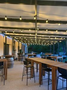 a large patio with tables and chairs and lights at Domaine de cézille-Appart hôtel le Moulin du lac "Paul" in Jayat