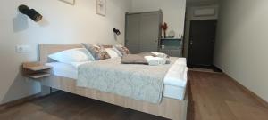a bedroom with a large bed with white pillows at Pingvin Panzió in Komárom +13 photos