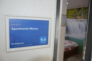 a sign on a door in a room at Apartments Mensa in Tuzla +60 photos