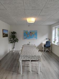 a white dining room with a table and chairs at Like home Holiday House 9 A in Varde