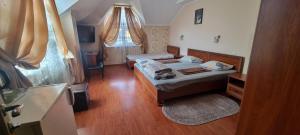 a small bedroom with two beds and a window at VILLA VERA in Berehove