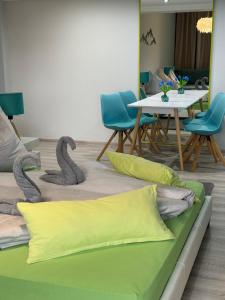 a room with two pillows and a table with chairs at Modern Oasis in Nová Lesná
