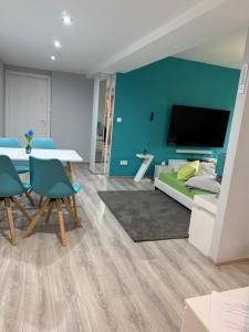 a living room with a dining table and a tv at Modern Oasis in Nová Lesná