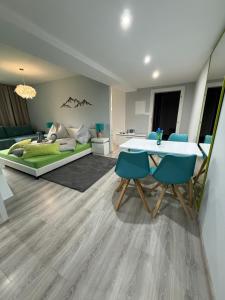 a living room with a table and chairs and a bed at Modern Oasis in Nová Lesná
