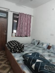 a bedroom with a bed and a window at Punchkedar in Phata +1 photo