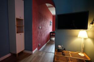 a living room with a tv on the wall at Venus and the Sea in Fezzano