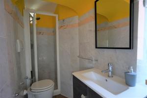 a bathroom with a sink and a toilet and a mirror at Venus and the Sea in Fezzano +18 photos