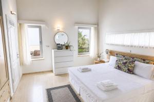 a white bedroom with a large bed and a mirror at Villa Emilie in Kaş +48 photos