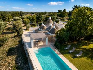 an aerial view of a villa with a swimming pool at Trulli Santa Maria dei Grani - Authentic Puglia Trulli with Private Pool & Scenic Garden in Ceglie Messapica