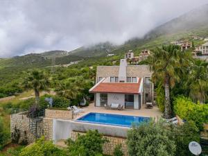 an aerial view of a house with a swimming pool at Villa Emilie in Kaş