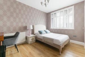 a bedroom with a bed and a window at Katolondonhaus in Mitcham