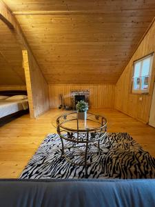 a room with a table and a zebra rug at Medvidske in Tukhlya