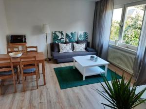 a living room with a couch and a table at Rikes Ferienwohnung 2 in Heinsberg