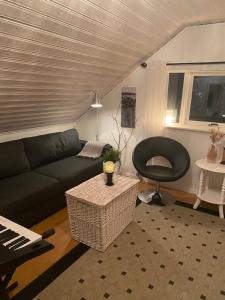 a living room with a couch and a chair at Yttermoveien in Narvik