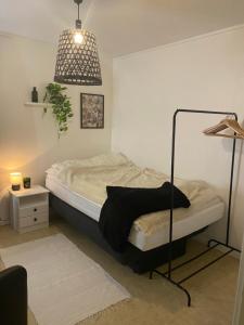 a bedroom with a bed and a pendant light at Yttermoveien in Narvik