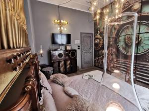 a bedroom with a bed and a tv in a room at The Kraken Inn - Steampunk Boutique B&B in Bergamo in Bergamo