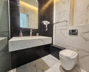 a bathroom with a toilet and a sink and a mirror at Pals Studios Pefkos in Pefki +19 photos