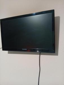a flat screen tv hanging on a wall at Irida mariaSmall studio in Agios Ioannis Pelio