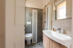 a bathroom with a white sink and a toilet at Vettori Hideaway by MMega in Florence +11 photos
