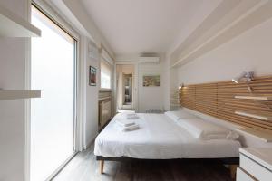 a bedroom with a large bed and a large window at Vettori Hideaway by MMega in Florence
