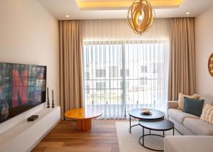 a living room with a couch and a tv at Aqualina C2-4 by HolidayKeys in Kyrenia