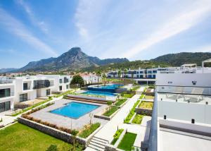 an aerial view of a building with two swimming pools at Aqualina C2-4 by HolidayKeys in Kyrenia