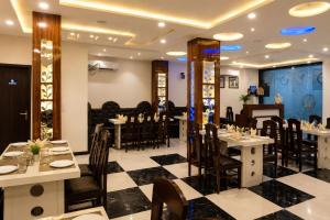 a restaurant with tables and chairs in a room at Hotel Boston Rooms by SOT - Affordable Stay near Taj #Parking #Ac #2 min drive to Taj in Agra