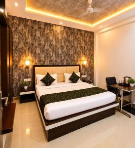 a bedroom with a large bed and a desk at Hotel Boston Rooms by SOT - Affordable Stay near Taj #Parking #Ac #2 min drive to Taj in Agra