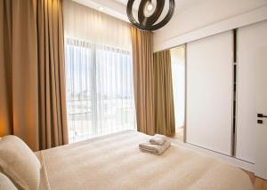 a bedroom with a bed and a large window at Aqualina C2-4 by HolidayKeys in Kyrenia