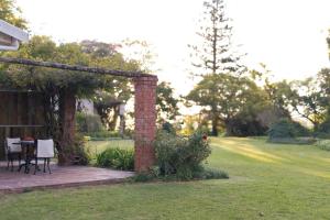a patio with a table and chairs in a yard at Clivedon Cottage in Sunland