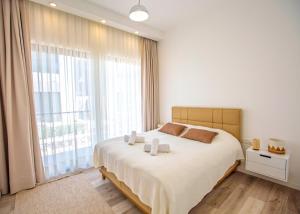 a bedroom with a large bed and a large window at Aqualina B3-2 by HolidayKeys in Kyrenia