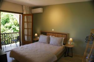 a bedroom with a bed and a balcony at Villa Elizabeth Apartments in Ouranoupoli