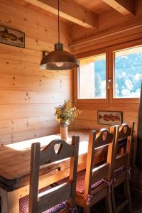a dining room with a table and two chairs at Le chalet d'en ô in Les Clefs +17 photos