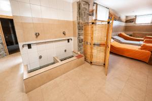 a bathroom with a shower and a bed in a room at Férovka in Jeseník +60 photos
