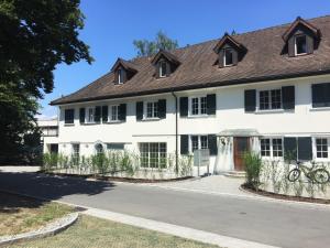 a white house with black windows at Appartement "Suite Seeliebe" in Tägerwilen