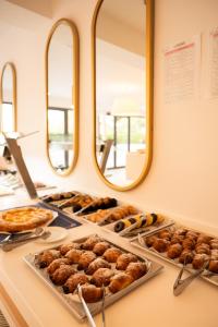 a buffet with trays of donuts and other pastries at Sol i Vida Hotel - Adults Only in Porto Cristo