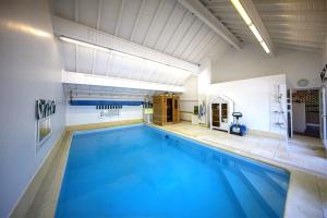 a large indoor pool with a large blue swimming pool at Zenitude Villa - Indoor Pool & Jacuzzi in Jezainville