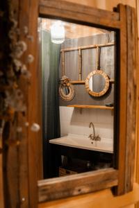a bathroom with a sink and a mirror at Le chalet d'en ô in Les Clefs