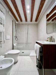 a bathroom with a toilet sink and a shower at Casanova Hideaway in Venice +49 photos