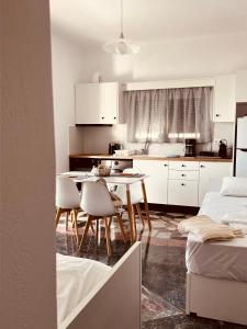 a kitchen and dining room with a table and chairs at Alkisti's seaside apartments in Pythagoreio