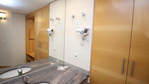 a bathroom with a sink and a mirror at 1309 - Hotel & Residence Sol Alphaville Flat in Barueri