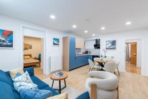 ein Wohnzimmer mit einer blauen Couch und eine Küche in der Unterkunft Guesthouse Casa Nova in Poreč