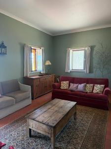 a living room with a couch and a coffee table at Casa do Cardal in Casével