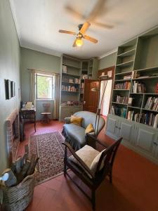 a living room with a couch and a fan at Casa do Cardal in Casével