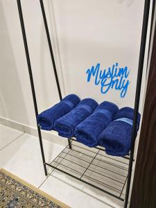 a group of blue pillows sitting on a rack at Homestay Seri Damai in Juasseh +27 photos