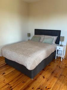 a bedroom with a large bed with a night stand at Fanore Apartment 3 in Fanore