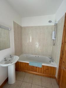 a bathroom with a bath tub and a sink at Fanore Apartment 3 in Fanore