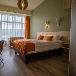 a bedroom with a large bed and a window at Hotel Hallormsstadur in Egilsstaðir
