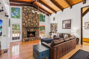 a living room with a couch and a fireplace at Sues Lake House in Buford