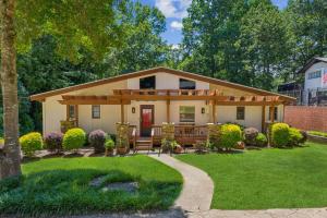 a small house with a porch and a lawn at Sues Lake House in Buford